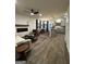 Open concept living room featuring a fireplace, furniture, and wood floors leading to the kitchen at 247 Ivey Ter # 45, Temple, GA 30179
