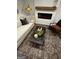 Inviting living room with a plush sofa, electric fireplace, designer rug, and chic decor for relaxed living at 247 Ivey Ter # 45, Temple, GA 30179
