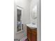 A charming bathroom showcases an oval mirror over a wooden vanity and a view into the bedroom at 1119 Highway 54 East, Fayetteville, GA 30214