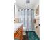 Bathroom with wood vanity, shower with curtain, and green rug at 1119 Highway 54 East, Fayetteville, GA 30214