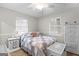 This serene bedroom features a comfy quilt, bright natural light and a white wicker dresser at 1119 Highway 54 East, Fayetteville, GA 30214