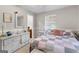 This beautifully decorated bedroom features bright natural lighting and a white wicker vanity at 1119 Highway 54 East, Fayetteville, GA 30214