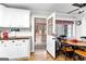 Eat-in kitchen with white cabinets and access to an enclosed back porch at 1119 Highway 54 East, Fayetteville, GA 30214