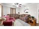 Carpeted living room features two couches, an armchair, and ceiling fan at 1119 Highway 54 East, Fayetteville, GA 30214