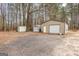 Multiple outbuildings in a wooded setting offer plenty of additional storage or hobby space at 1119 Highway 54 East, Fayetteville, GA 30214