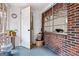 Enclosed porch area showcasing a window, brick accents, and a view into laundry area at 1119 Highway 54 East, Fayetteville, GA 30214