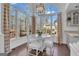 Dining area with a hardwood floors, a clear glass table top and large windows with backyard views at 407 Blue Smoke Trl, Peachtree City, GA 30269