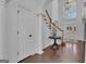Elegant foyer featuring a staircase, doorway, and decoratively column, leading to other rooms in the home at 407 Blue Smoke Trl, Peachtree City, GA 30269