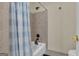 Shower with a light blue and white striped shower curtain with a tile surround at 407 Blue Smoke Trl, Peachtree City, GA 30269