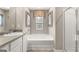 Clean bathroom featuring separate shower, soaking tub, vanity, and neutral decor at 362 Friendship Oak Way, Hampton, GA 30228