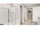 Bright bathroom featuring a glass shower with built-in shelves, and neutral walls at 362 Friendship Oak Way, Hampton, GA 30228