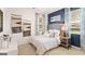 Cozy bedroom with a blue accent wall, plush bedding, and lots of natural light from the window at 362 Friendship Oak Way, Hampton, GA 30228