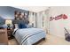 Bedroom with a blue accent wall, Braves decor, and natural light from the windows at 362 Friendship Oak Way, Hampton, GA 30228