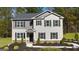 Inviting two-story home featuring a modern design with professional landscaping at 362 Friendship Oak Way, Hampton, GA 30228