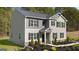 Attractive two-story home with well-manicured landscaping, a covered porch, and neutral siding at 362 Friendship Oak Way, Hampton, GA 30228