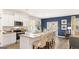 Eat-in kitchen featuring an island with bar seating, stainless appliances, and wood flooring at 362 Friendship Oak Way, Hampton, GA 30228