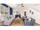 Comfortable living room featuring a large window, stylish furniture, and a cozy area rug at 362 Friendship Oak Way, Hampton, GA 30228
