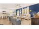 Inviting living room with bright blue accent wall, modern furniture, and an open layout to the kitchen at 362 Friendship Oak Way, Hampton, GA 30228