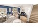 Open-concept living space featuring a granite countertop island and a staircase to the second story at 362 Friendship Oak Way, Hampton, GA 30228