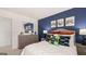 Modern bedroom with a blue accent wall, video game decor, and cozy furnishings at 358 Friendship Oak Way, Hampton, GA 30228