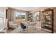 Bright home office with a large window, dual desks, and stylish shelving for a productive workspace at 358 Friendship Oak Way, Hampton, GA 30228