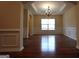 Formal dining room featuring hardwood floors, elegant wainscoting, and a stylish chandelier at 312 Villa Place Ct, Tucker, GA 30084