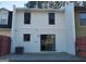 Back exterior of the townhome with sliding glass door and a concrete patio at 746 Dunaire Way, Jonesboro, GA 30238