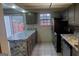 Kitchen featuring new stainless steel appliances, gray cabinets and tiled floors at 746 Dunaire Way, Jonesboro, GA 30238