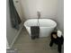 Freestanding bathtub with chrome faucet and gray towel nearby at 11563 Kimberly Way # 23, Hampton, GA 30228