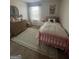 Cozy bedroom featuring a pink bed frame, patterned rug, window, and wood dresser at 11563 Kimberly Way # 23, Hampton, GA 30228