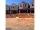 New townhome construction featuring brick accents, modern design, and a visible garage at 11563 Kimberly Way # 23, Hampton, GA 30228