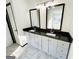 Bathroom features double sink vanity with dark countertops and white cabinets, and ceramic tile flooring at 6159 Sable Fox Dr, Riverdale, GA 30296