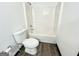 Bathroom featuring shower-tub combo, toilet, and wood look floors at 6159 Sable Fox Dr, Riverdale, GA 30296