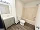 Bathroom featuring shower-tub, toilet, and vanity with modern fixtures at 6159 Sable Fox Dr, Riverdale, GA 30296