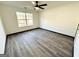 Bedroom with wood look floors, ceiling fan, neutral paint and large window at 6159 Sable Fox Dr, Riverdale, GA 30296