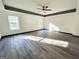 Large bedroom with tray ceiling, wood look floors, and natural light at 6159 Sable Fox Dr, Riverdale, GA 30296