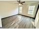 Bedroom featuring a ceiling fan, wood look floors, and natural light from two windows at 6159 Sable Fox Dr, Riverdale, GA 30296