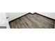 Close up of gray-toned wood flooring and dark trim at 6159 Sable Fox Dr, Riverdale, GA 30296