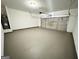 Spacious garage with grey painted floors and an automatic roll up door at 6159 Sable Fox Dr, Riverdale, GA 30296