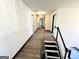 Hallway with wood look floors and black painted stair railing at 6159 Sable Fox Dr, Riverdale, GA 30296