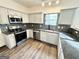 Modern kitchen with stainless steel appliances, granite countertops, and stylish backsplash, ideal for cooking and entertaining at 6159 Sable Fox Dr, Riverdale, GA 30296