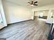 Bright living room with modern ceiling fan and open floor plan seamlessly connecting to the dining area at 6159 Sable Fox Dr, Riverdale, GA 30296