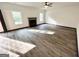 Inviting living room featuring a cozy fireplace, large windows, and new wood flooring for a modern touch at 6159 Sable Fox Dr, Riverdale, GA 30296