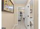 Well-lit hallway with tile flooring leading to the laundry room, providing easy access to household tasks at 105 Queens Gate, Fayetteville, GA 30215