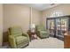 Sitting room features two green recliners, carpet, neutral walls, and natural lighting at 105 Queens Gate, Fayetteville, GA 30215