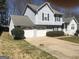 Charming two-story home with a two-car garage and traditional siding and landscaping at 1574 Elizabeth Ln, Hampton, GA 30228