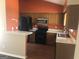 Traditional kitchen with warm wood cabinets, black appliances, and a peninsula counter at 1574 Elizabeth Ln, Hampton, GA 30228