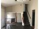Bright living room featuring a cozy fireplace, and stairs with wood railing leading up at 1574 Elizabeth Ln, Hampton, GA 30228