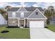 Charming two-story home with a brick and gray siding exterior and a well-manicured lawn at 3764 Saddle Bag Ct, Dacula, GA 30019