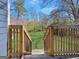 View of backyard with wooden deck and stairs leading to lawn at 340 Cedar St, Social Circle, GA 30025